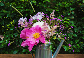 summer bouquet of blooming peonies and wildflowers