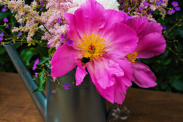 summer bouquet of blooming peonies and wildflowers