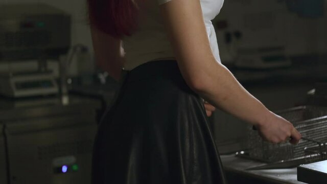 Sexy beautiful redhead ginger woman in black sexy knee high socks in the kitchen. Sensual woman cooking in the kitchen.