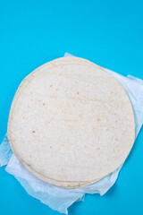 tortilla on white paper on blue background