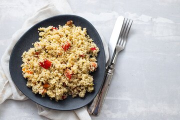 tabbouleh on dark plate on ceramic background