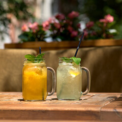 Cold and refreshing citrus fruit lemonade in mason jars with orange , lime and lemon.