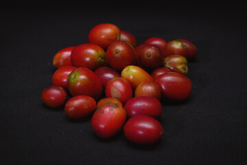 cherry tomatoes on black background