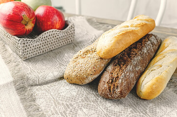 Different types of home-baked bread are on the table. Food background. Selective focus