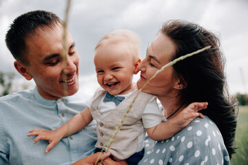 A happy family walks with a child in nature