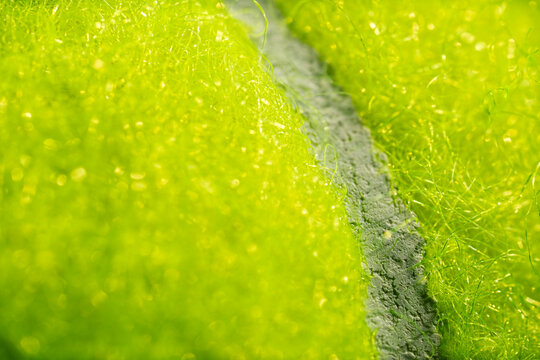 Extreme macro photo of a tennis ball. Sports background.