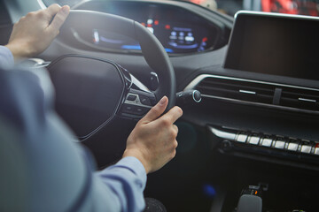 female hands on the steering wheel of a car