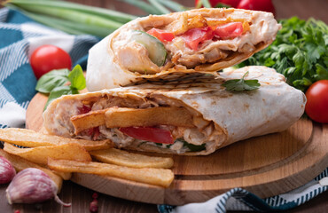 Burrito with grilled chicken and vegetables (fajitas, pita bread, shawarma).Close-up
