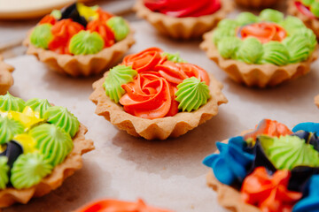 The process of making a tartlet cake. Tart cake. Cake basket. The process of filling cream cakes. Cream with food colors. Dye colored cream. Home kitchen. Homemade Tart Basket Cakes