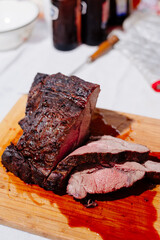 Beef steak with blood. Grilled beef with blood. The cook cuts the grilled beef. A large piece of grilled beef. The texture of the meat.