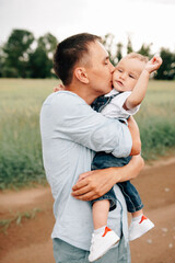 Obraz premium A happy family walks with a child in nature