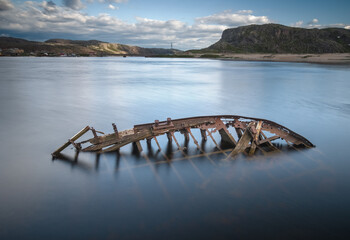 An old shipwreck or wrecked boat abandoned stand on beach