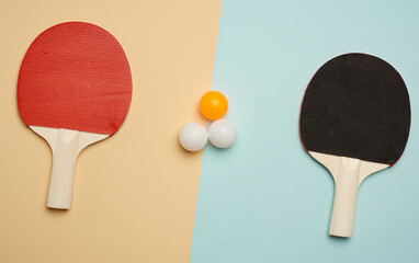 two wooden rackets and plastic balls for playing table tennis
