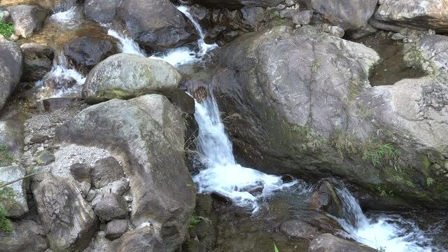 Waterfall passing through rocks. Footage shot at Jhalong, Dooars, West Bengal, India. Dooars is famous for it;s scenic beauty.