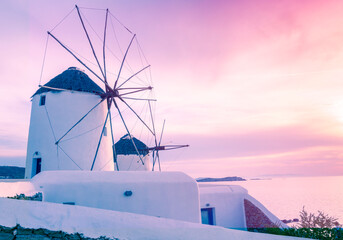 Pink and purple stunning sunset at Mykonos Island at the famous windmills sunset point in Greece. - obrazy, fototapety, plakaty