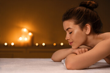 Obraz na płótnie Canvas Sleeping lady laying on massage table at spa