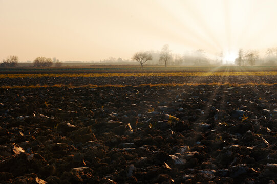 Plowed Soil. Spring Field. Sunset Over Ploughed Field. Countryside Lanscape. Vintage Polaroid Filter Applied.