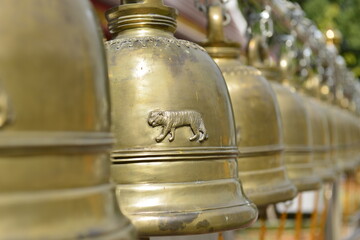 Golden buddhist bell at Wat Phra That Sri Chom Thong in Chiang Mai province, Thailand.