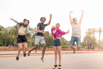 Happy friends jumping in the city