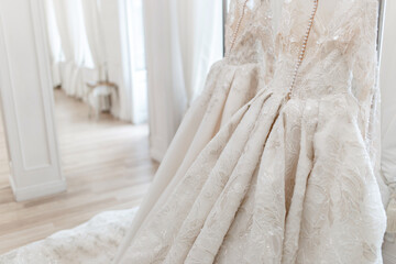 Fototapeta na wymiar wedding dress close up. white pearls and patterns
