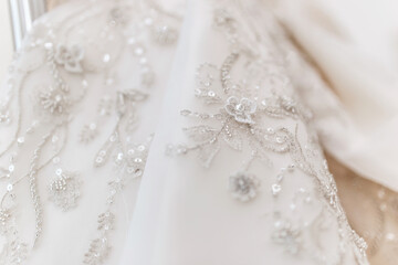 wedding dress close up. white pearls and patterns