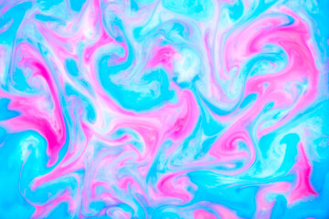 Abstract blue and pink spots on a white liquid. Creative bright background made of liquid texture.