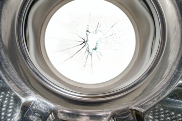 Broken glass in the washing machine door with black background