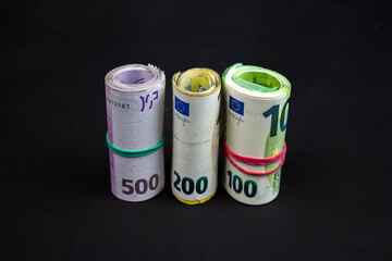 Standing and rolled euro notes. 100, 200 and 500 banknotes. A total of several thousand euros.
