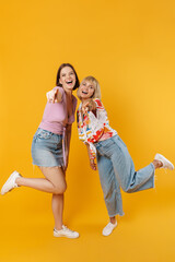 Portrait of two cheerful lovely girlfriends standing