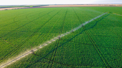 farming irrigation sprinklers system on cultivated agricultural landscape field. aerial view