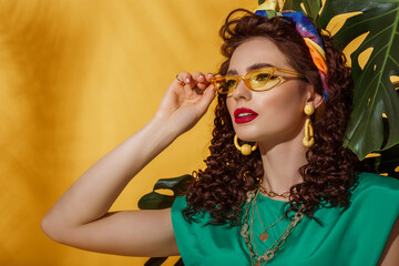 Summer fashion portrait of beautiful curly woman with fuchsia color lips makeup, wearing trendy...