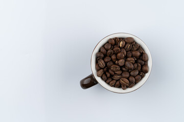 Spanish coffee, cup with a heap of coffee beans inside, isolated on white background, studio photoshoot for catalogue