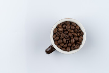 Balinese specialty coffee, beans in a cup, directly above, isolated on white, studio shot