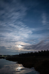 Dramatic blue dawn sky over the pond