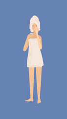 Young woman standing and holding cream in her hand and moisturizing her skin