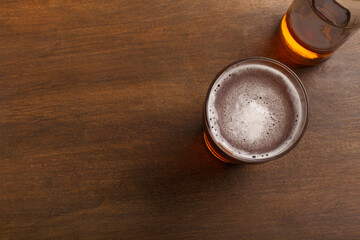 Fresh tasty beer. Bright lager with foam in glass and in bottle