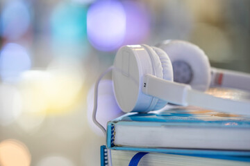 Headphones with books, educational concept.