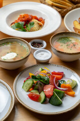 Lunch in a cafe: summer salad, pasta and mushroom cream-soup