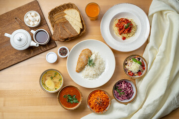 Top view of lunch buffet: various russian soups and salads, with pasta and rice as a second course