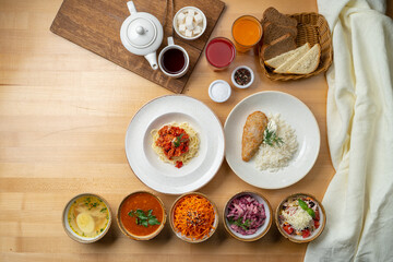 Top view of lunch buffet: various russian soups and salads, with pasta and rice as a second course