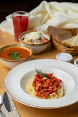 Perfect dinner in a cafe: cabbage tomato soup, pasta and coleslaw, close up photo