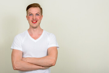 Obraz premium Portrait of young man with beard stubble wearing makeup