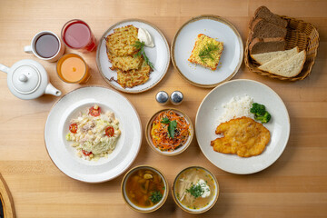 Russian buffet: assorted soups, salads and appetizers, cabbage soup, borscht, mushroom soup, fruit drinks, coated herring