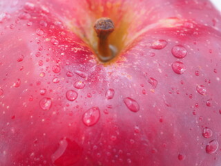 red apple in droplets on a white background