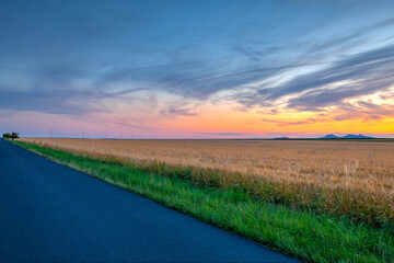 Naklejka na ściany i meble Barley field and amazing sunset in Czech Republic