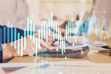 Financial trading graph multi exposure with man desktop background.