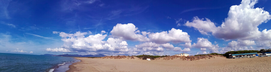 Italy, Tuscany, Maremma, Marina di Grosseto panoramic photo from the beach, in the background the port and castle of Castiglione della Pescaia.