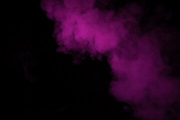 Colorful smoke close-up on a black background. Blurred pink cloud of smoke.