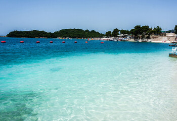The beautiful beach of Ksamil in a sunny day with clear turquoise water at Sarande, Albania.
