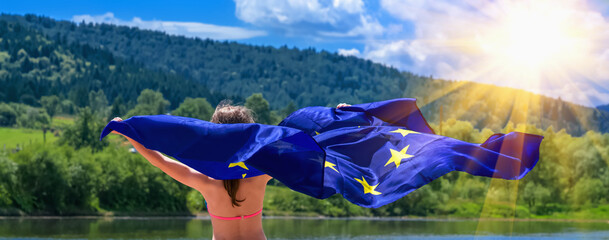 Child protection in Europe concept. Cute happy young beautiful girl dancing with the flag of the...